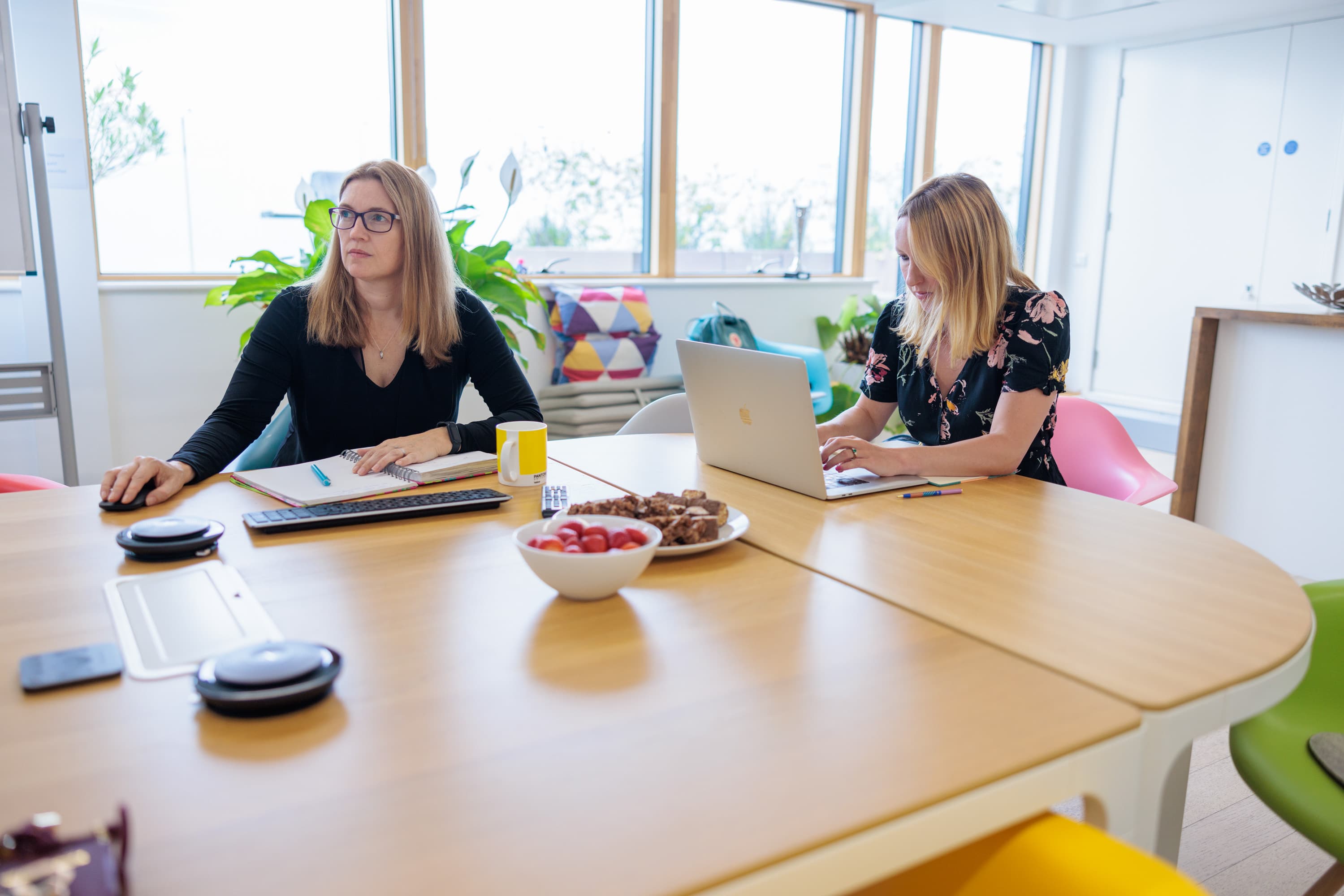 Two members of the Unified team holding a remote meeting the offices of our Adobe Commerce agency in London.