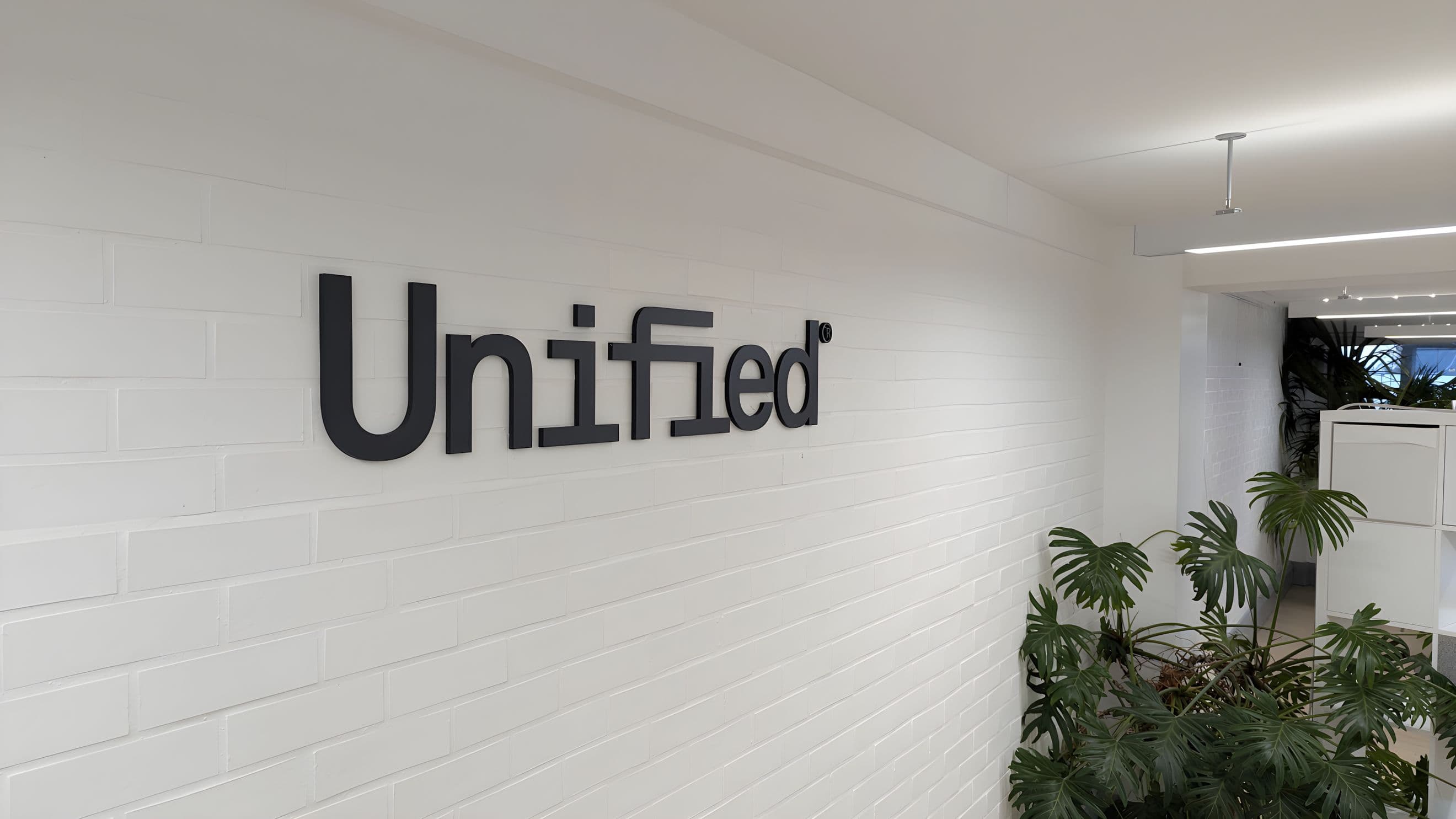 The Unified logo on the office wall of our ecommerce agency in London.